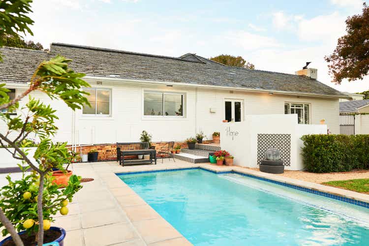 Swimming pool and patio in the backyard of a contemporary home