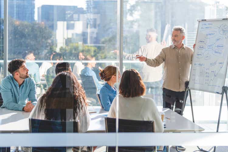 Business people watching a presentation on the whiteboard.