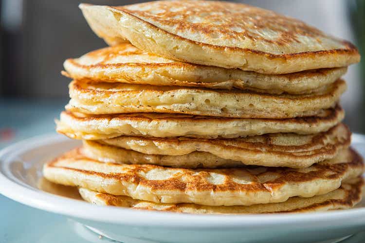 Macro closeup side view of stack of buttermilk pancakes on plate as traditional breakfast brunch dessert