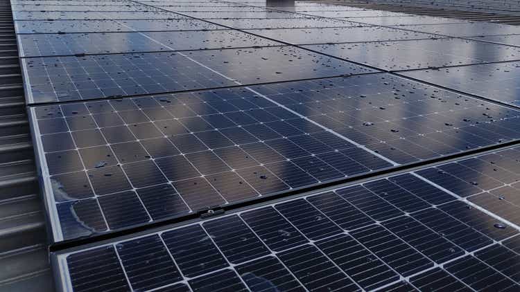Closeup of photovoltaic panels on a rooftop. Reflecting photovoltaic modules on a rooftop.