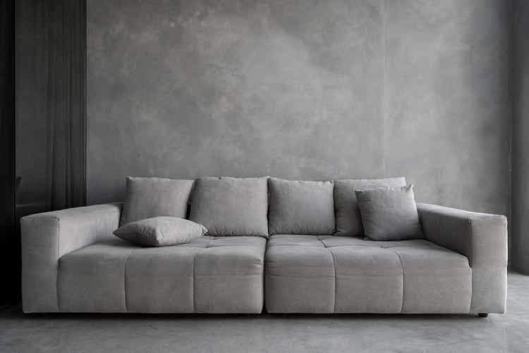 Modern and comfort sofa in apartment grey interior