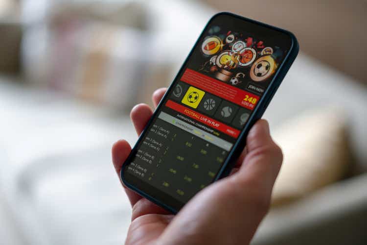 Close-up on a man gambling on a football app