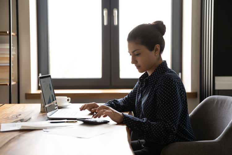 Focused female accountant working from home office