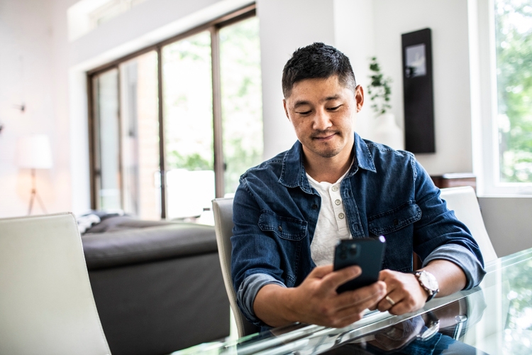 Man using mobile device at home