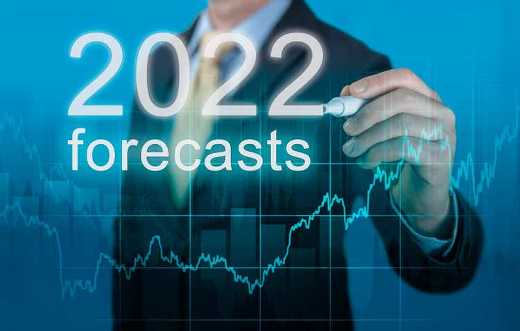economic forecasts for 2022. businessman writes forecasts for 2022 on virtual screen. New Year 2022 forecasts. Businessman in suit forecast analysis plan profit chart with pen