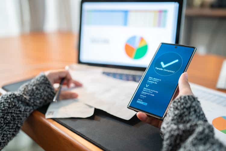 Woman Using banking app on the smartphone pay utility bill, financial Technology internet banking concept