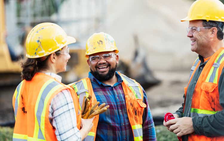 Three multi-ethnic construction workers chatting
