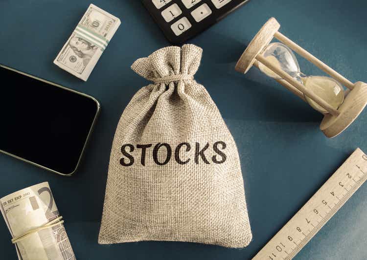 Money bag with the word Stocks. Trading on the stock exchange. Investment portfolio. Capital gains. Common and preferred stocks. Market trading and pricing. Share price determination.