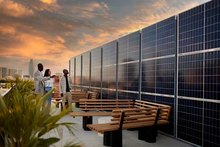 Broker and Prospective Buyers Admiring Solar Energy System