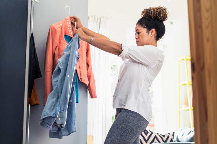 Woman organizing closet at home