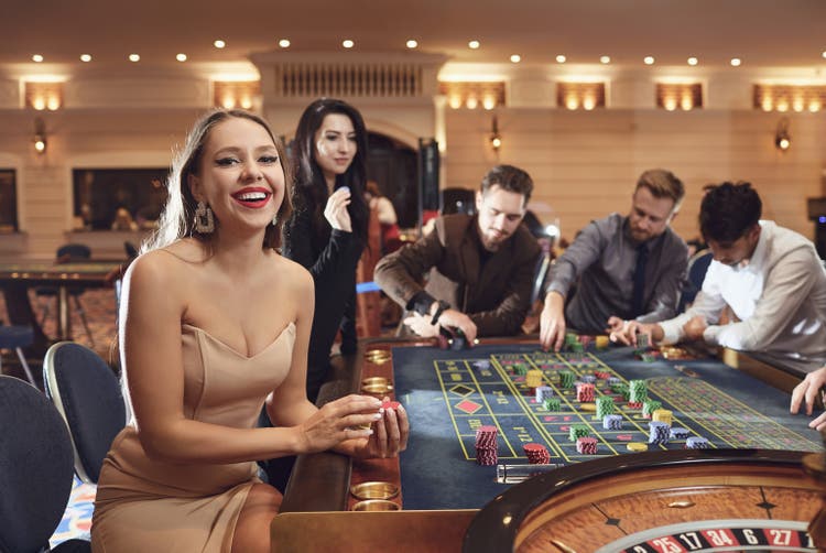 Happy smiling girl smiling at the roulette in a casino