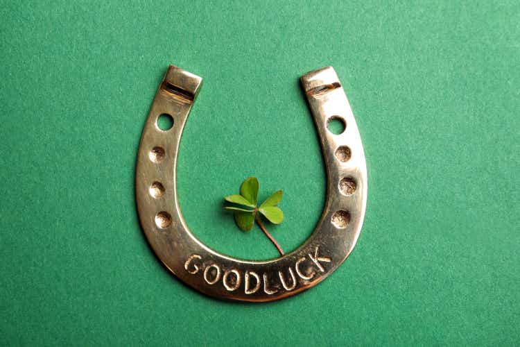 Flat lay composition with horseshoe on green background. St. Patrick"s Day celebration