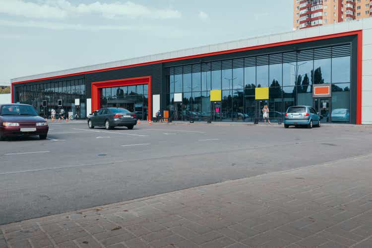 Supermarket outside with car parking and glass showcase