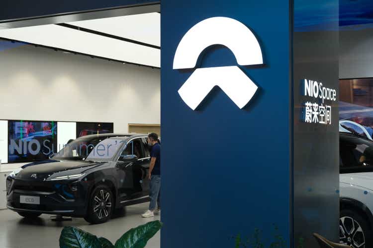 NIO store sign and customer in electric car store