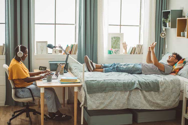 Friends at college dorm room