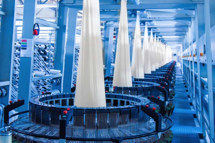 Production of white polypropylene flat yarn for the production of industrial bags. Allison-circular loom woven bag machine. Production of polypropylene sleeves. Shuttle.