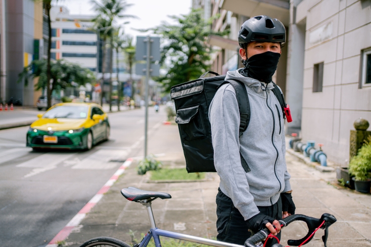 Portrait of a delivery man at the city.