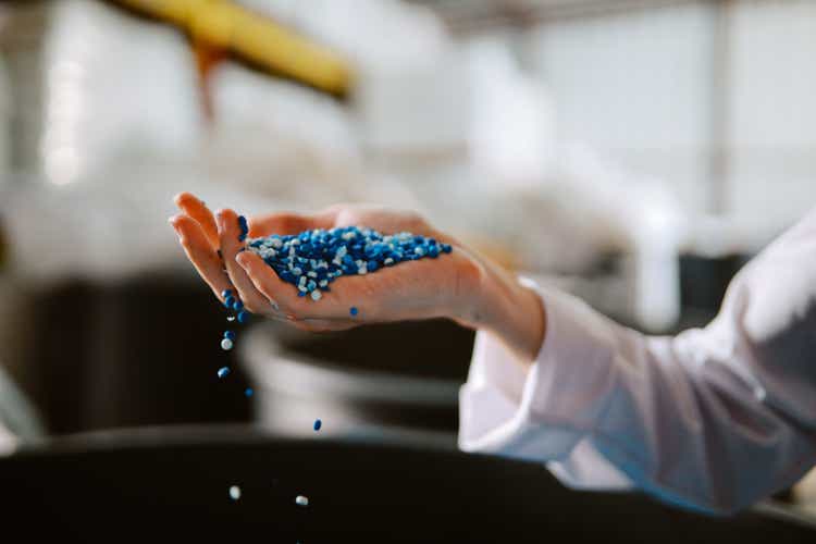 Female technician inspecting pellets made of biodegradable materials