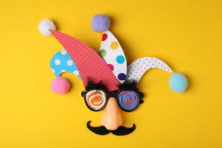 Funny face made of party items on yellow background, flat lay. April Fool"s Day