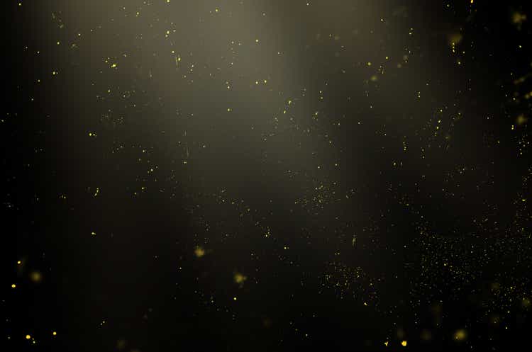 golden particles in the rays of light on a black background for use with the screen overlay mode