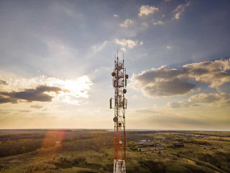 Antenna with 5G technology in rural countryside at sunset.