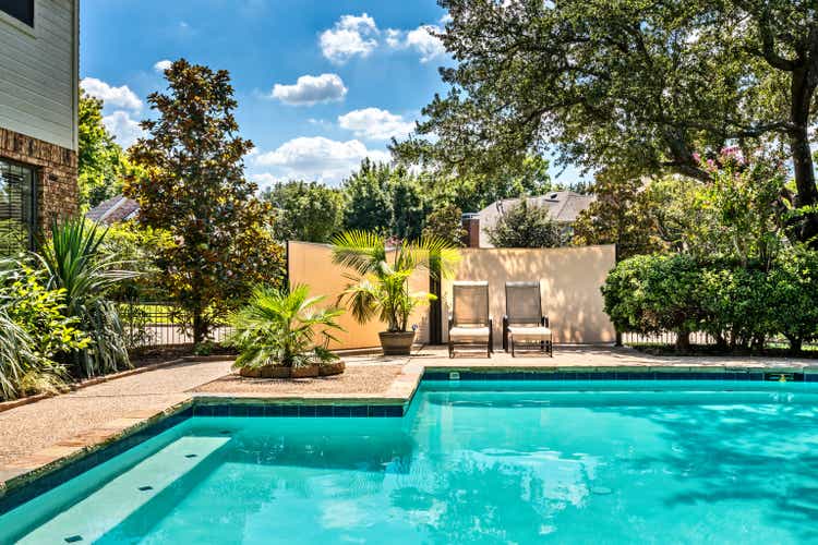 Backyard oasis with a swimming pool inside a private residential backyard