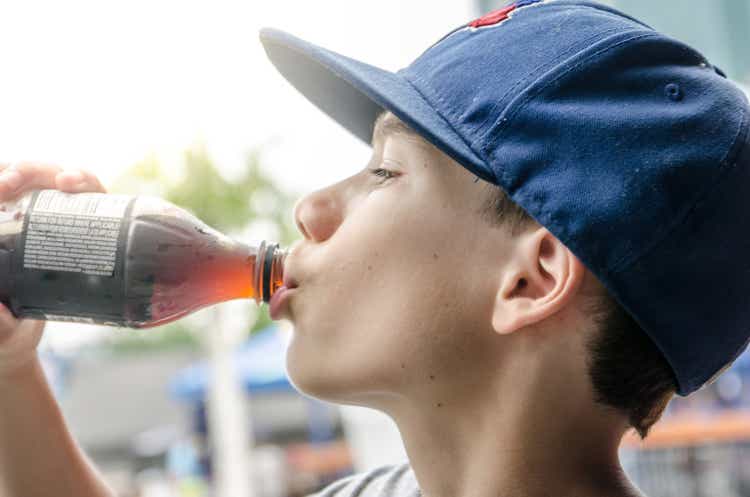 Headshot of boy drinking soda