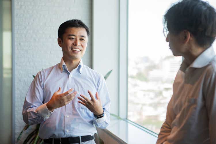 A man talking to a colleague during a break