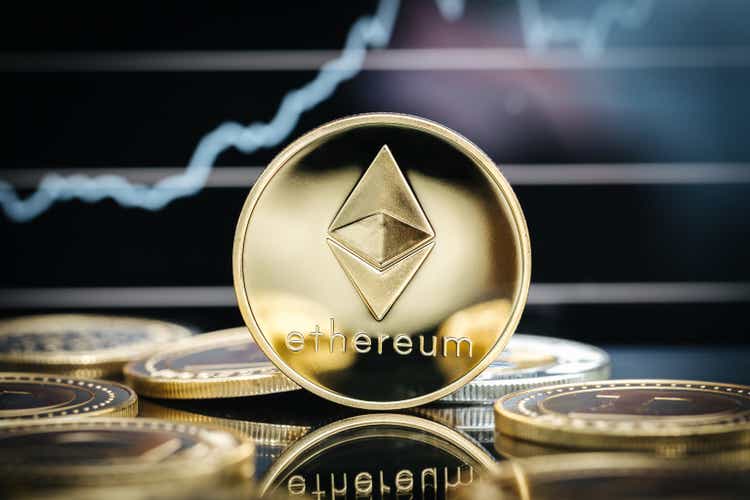 Cryptocurrency Ethereum, close-up of physical currency, in front of a price chart