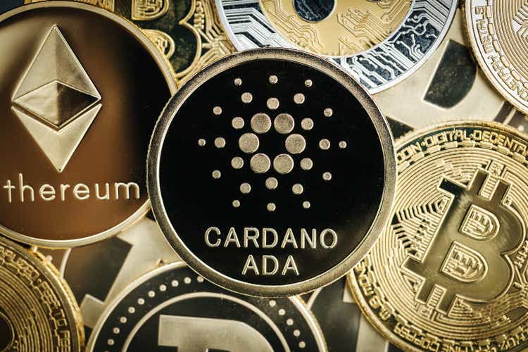 Cardano Ada cryptocurrency coin close-up, on top of other cryptocurrency coins