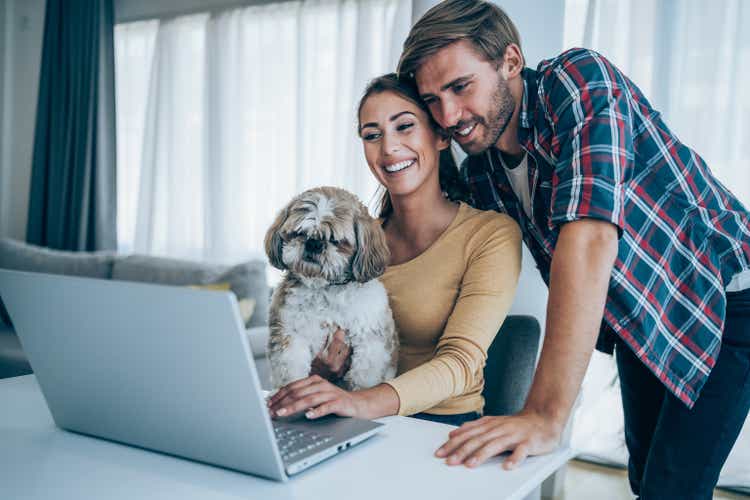 Cheerful couple having video call at home.