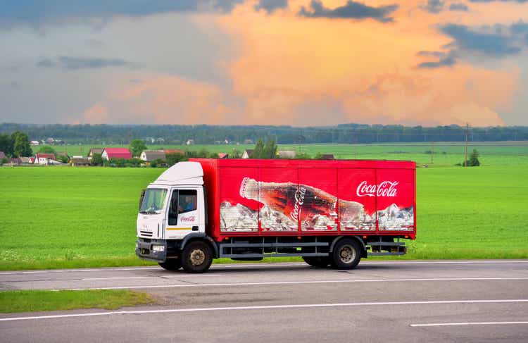 Coca Cola Truck with driving along highway. Goods Delivery by roads.