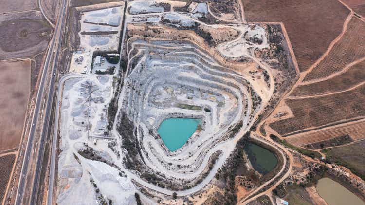 High angle shot of snowy excavation site along a dry and arid landscape