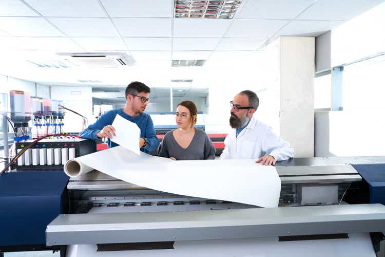 Printing team at industry plotter printer