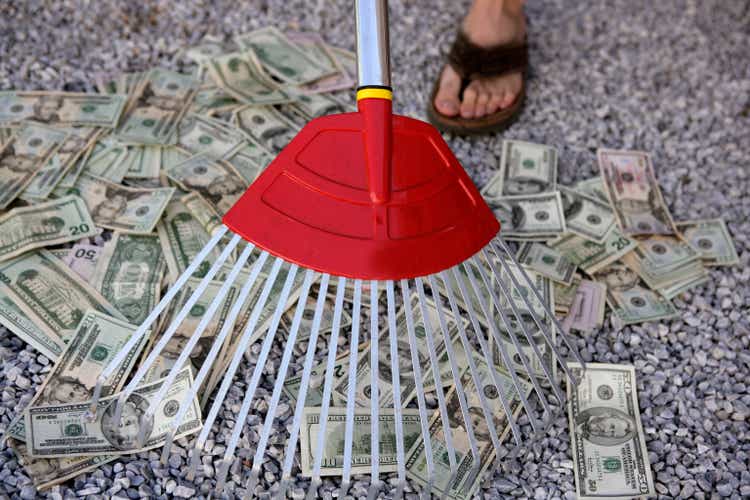 Cleaning black dolar money with rake, metaphor