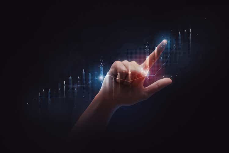 Businessman pointing finger to stock market finance graph chart exchange money or growth investment global economy analysis rate on economic technology background with digital trading data business.