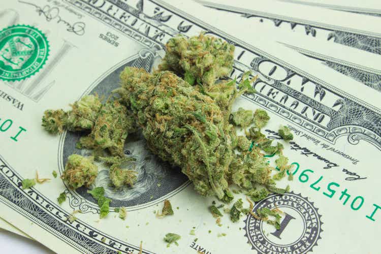 Cannabis and American money. Therapeutic and medicinal prescription marijuana. Sticky hemp buds of a hybrid strain.Concept of legal drug trade