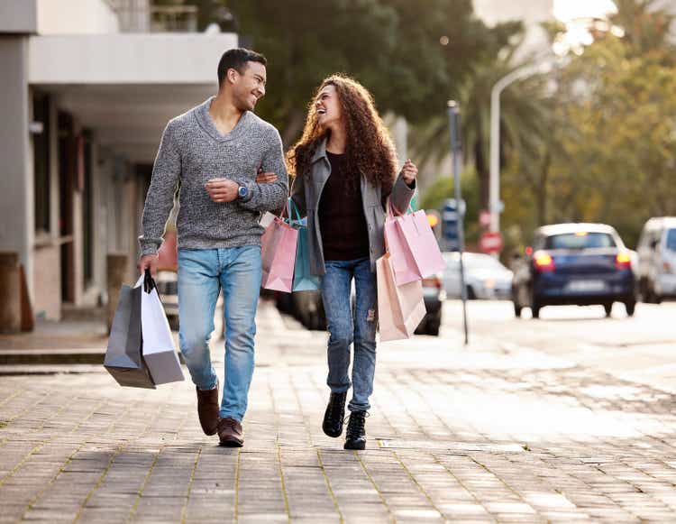 Full length shot of an affectionate young couple enjoying a shopping spree in the city