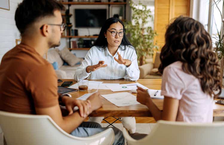 Young couple getting advice from financial expert