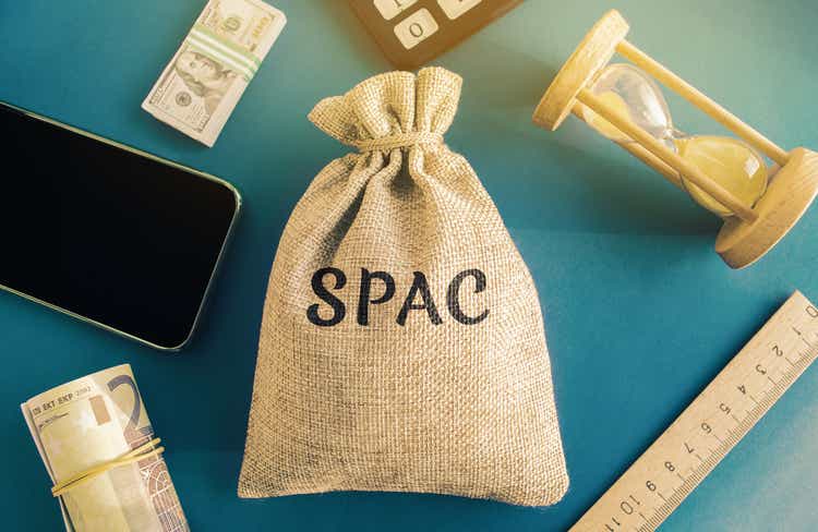 Money bag with the word SPAC - Special purpose acquisition company. Simplified listing of company, merger bypassing stock exchange IPO. Assessment of benefits and risks of investments