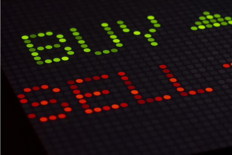 Financial BUY SELL trading information on a digital display.