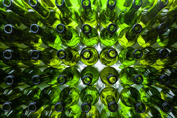 A large number of green glass bottles for recycling in an orderly manner