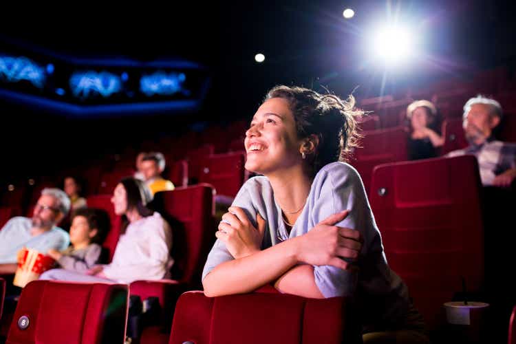 Girl enjoying watching a nice movie at the cinema