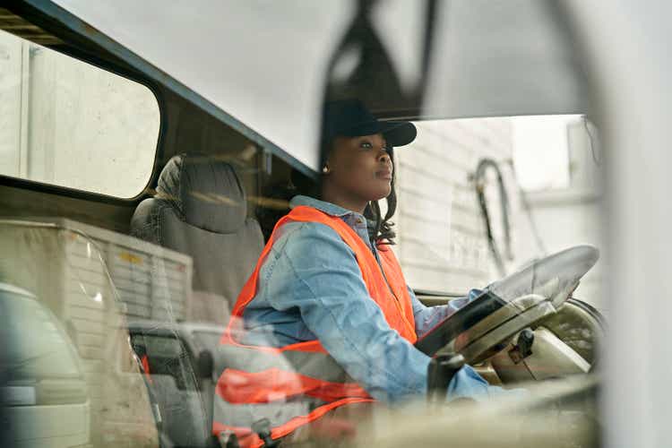 Black Female Truck Driver Photographed Through Window