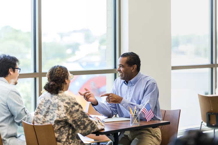 Female soldier and husband meet with mature male loan officer