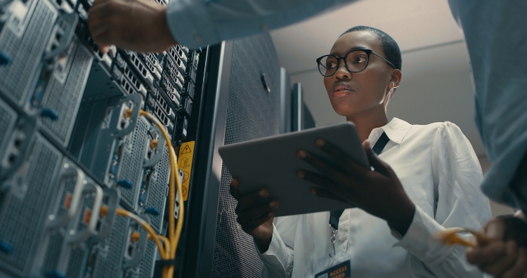 Shot of a man and woman using a digital tablet while working in a data centre