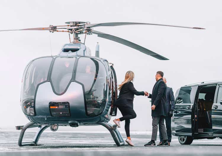Wealthy couple traveling by a private helicopter