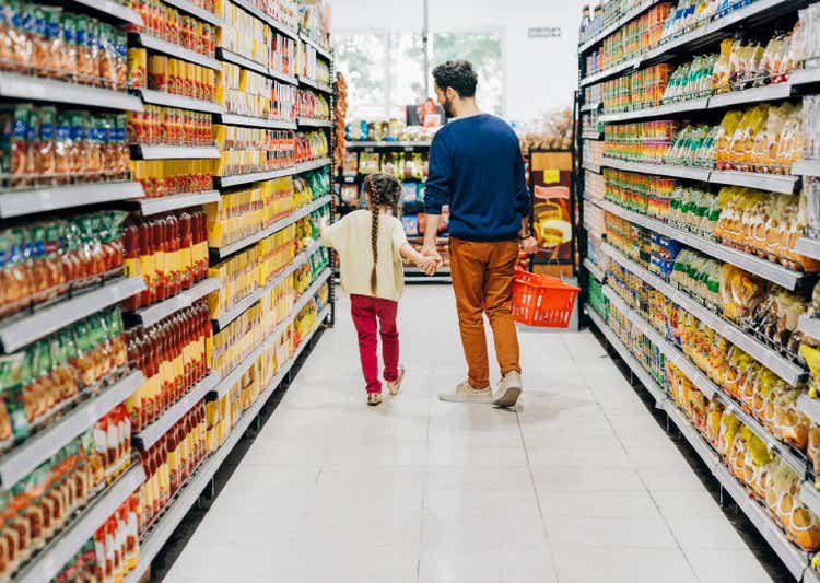 Daughter shopping with father in supermarket