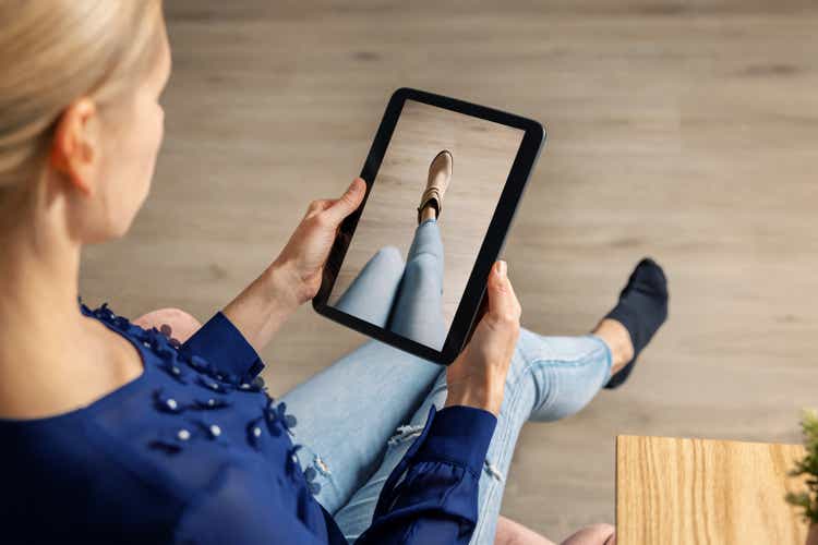 virtual fitting room - woman trying on shoes online with digital tablet