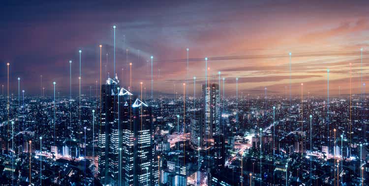 Telecommunications connections over smart city.  Futuristic cityscape concept for internet of things (IoT), fintech, blockchain, 5G LTE network, wifi hotspot access, cyber security, digital technology